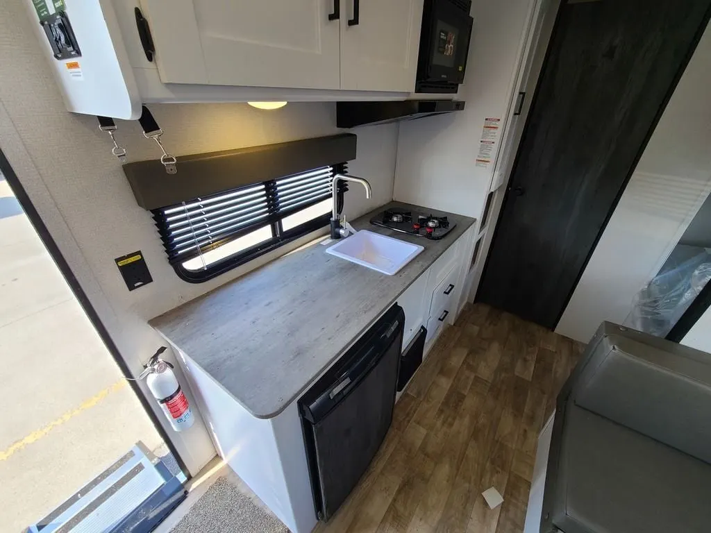 Kitchen with a gas range, oven, sink and cabinets.