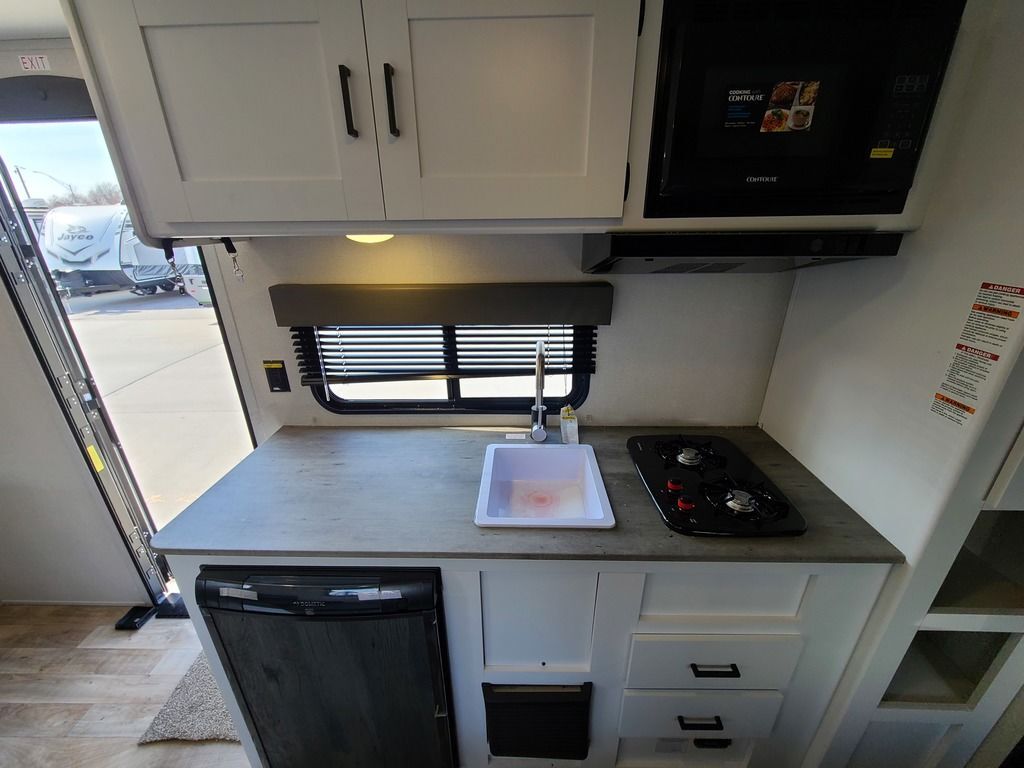 Kitchen with a gas range, oven, sink and cabinets.