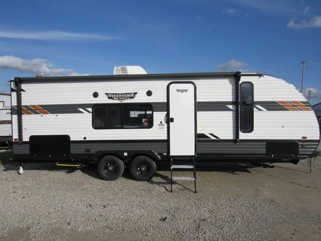 Side view of the New 2022 Forest River Wildwood X-Lite Midwest 261BHXL Travel Trailer RV.