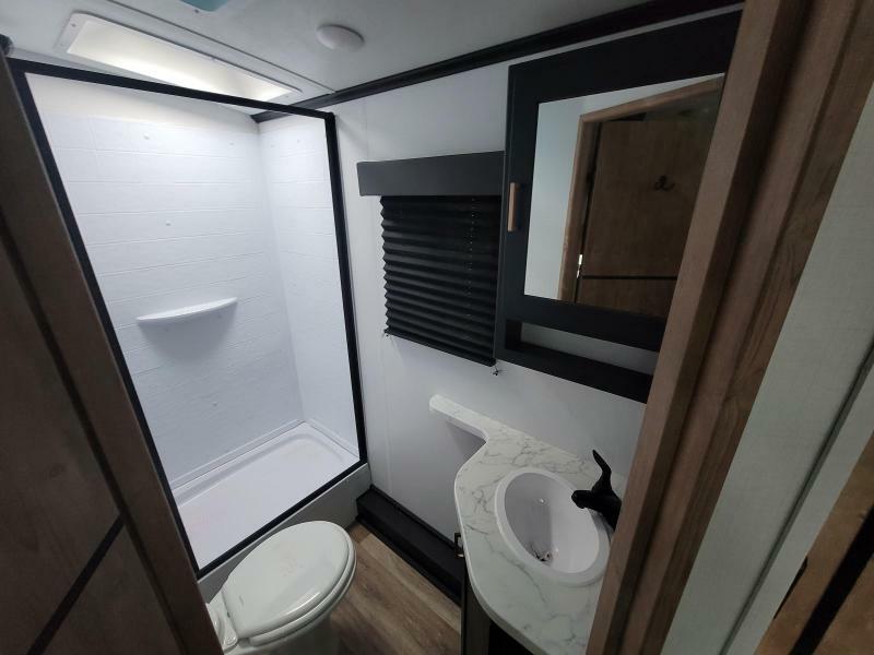 Bathroom with a sink, toilet and a shower.