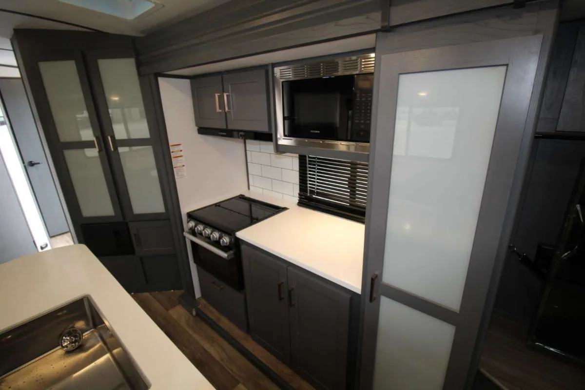 Kitchen with a gas range, oven, sink and cabinets.