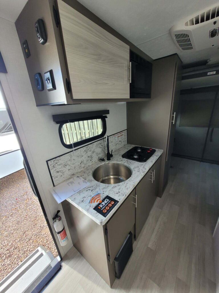 Kitchen with a gas range, oven, sink and cabinets.