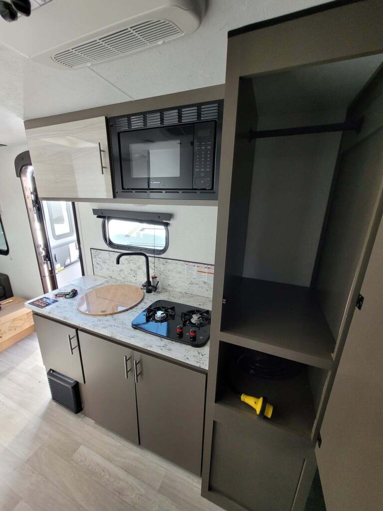 Kitchen with a gas range, pantry oven, sink and cabinets.