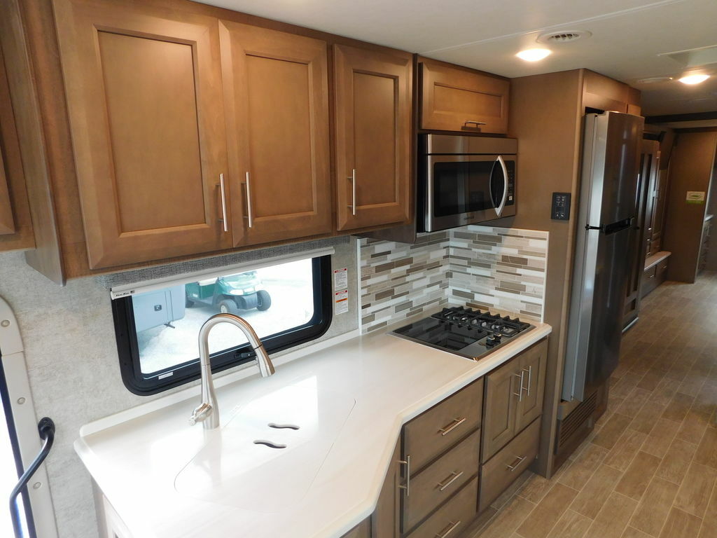 Kitchen with a gas burner, fridge, oven, sink and cabinets.