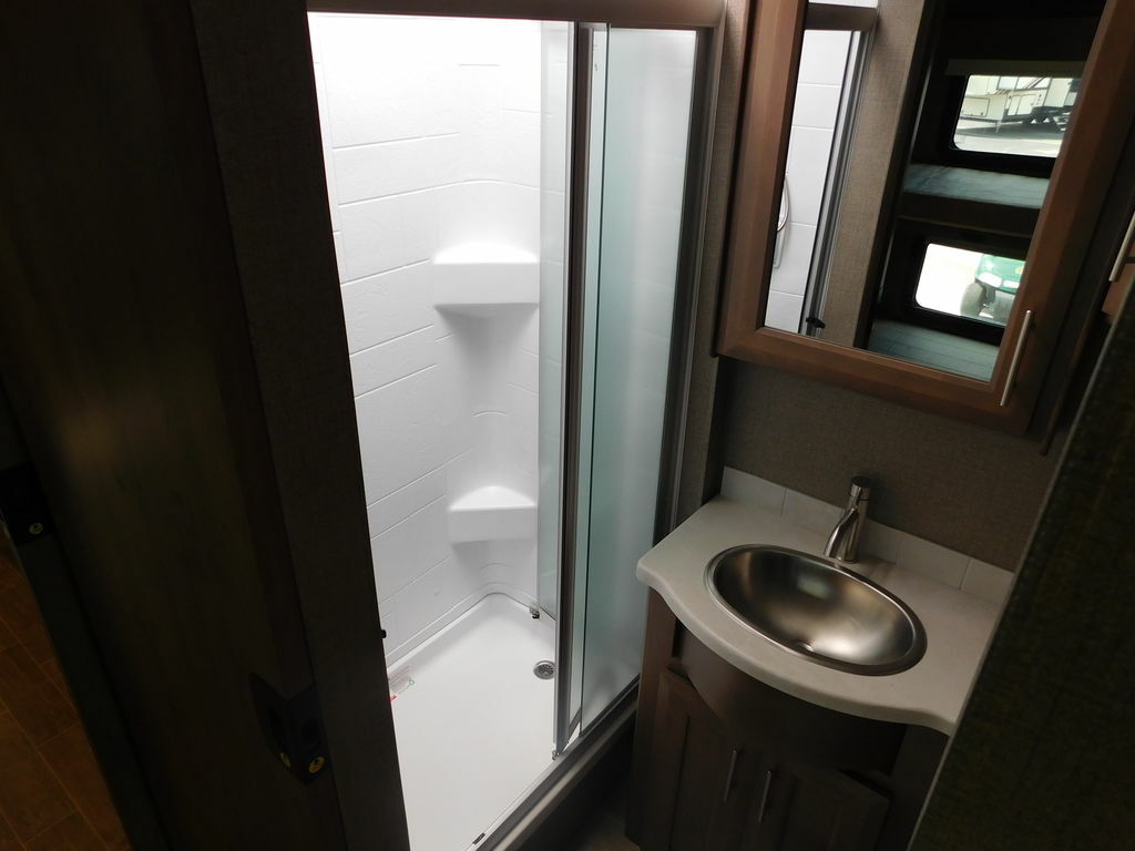 Bathroom with a sink, medicine cabinet and a walk-in shower.