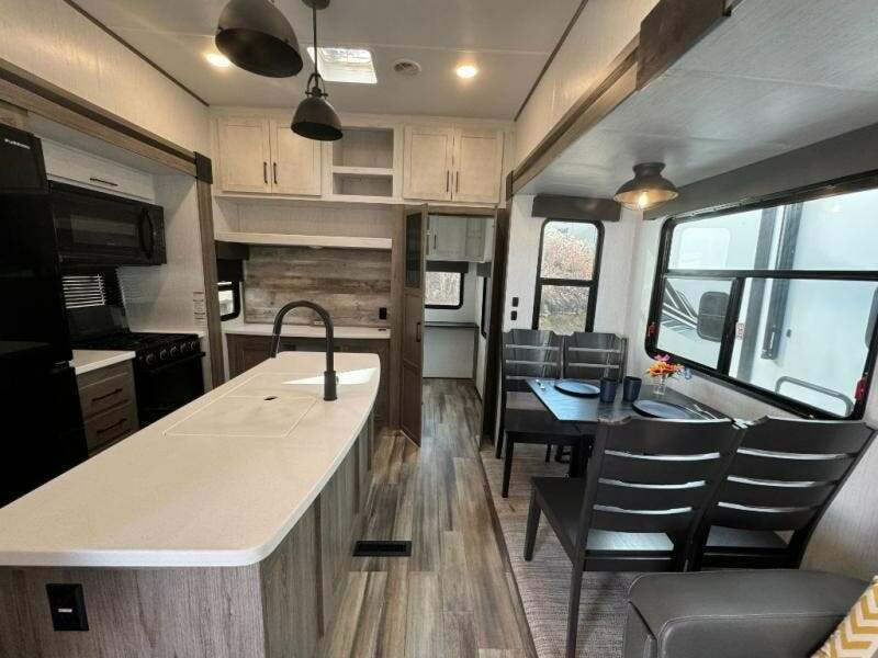 Interior view of the RV with a dinette and a kitchen.