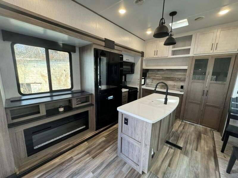 Kitchen with a gas burner, fridge, oven, sink and cabinets.