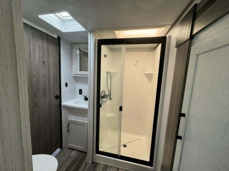 Bathroom with a sink, toilet and a walk-in shower.