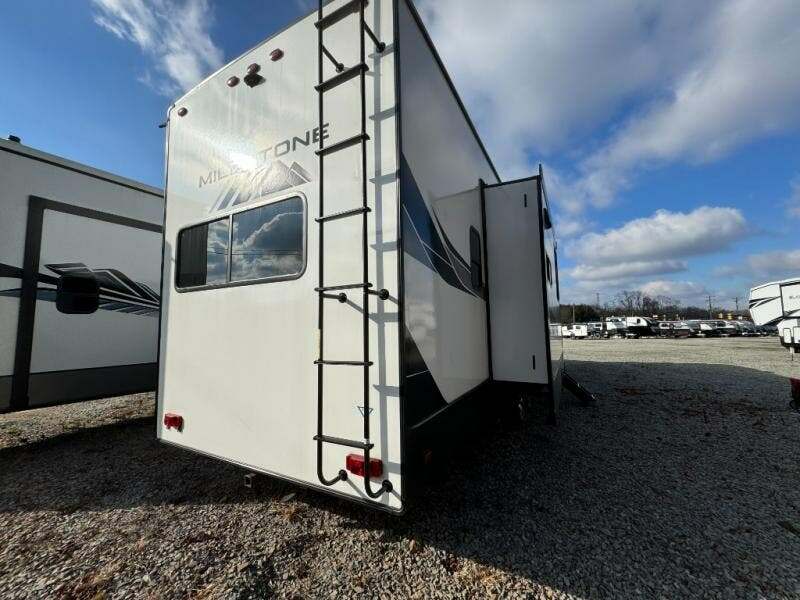 Rear view of the RV with a slide out.