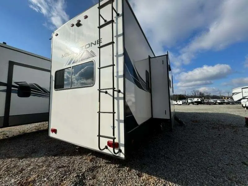 Rear view of the RV with a slide out.