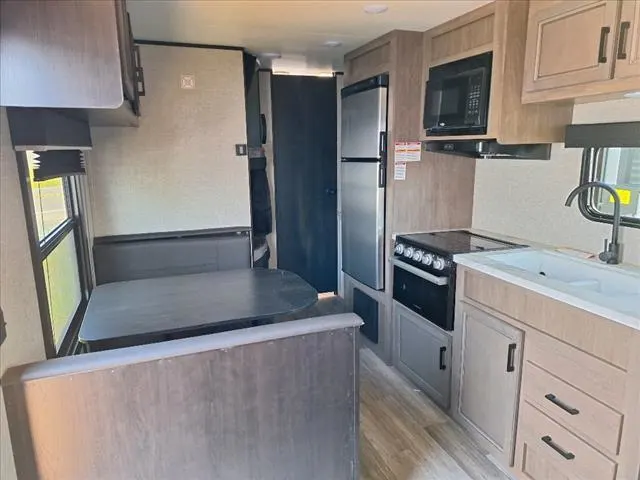 Interior view of the RV with a dinette and a kitchen.