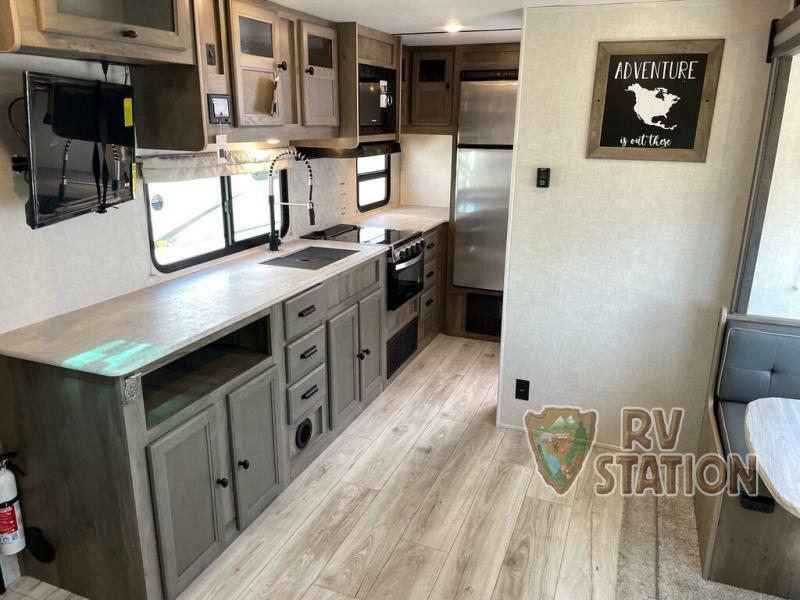 Kitchen with a gas burner, fridge, oven, sink and cabinets.