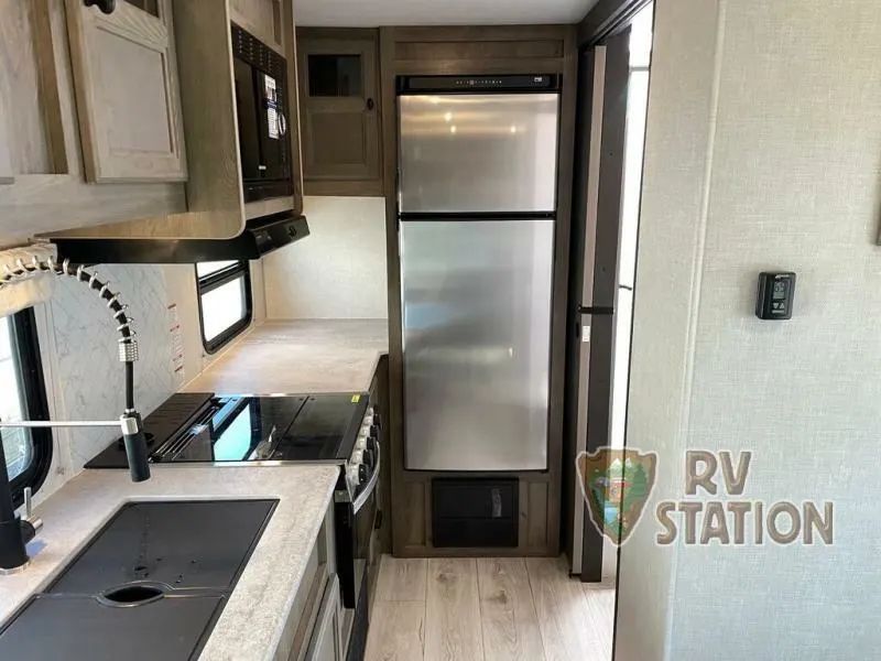 Kitchen with a gas burner, fridge, oven, sink and cabinets.