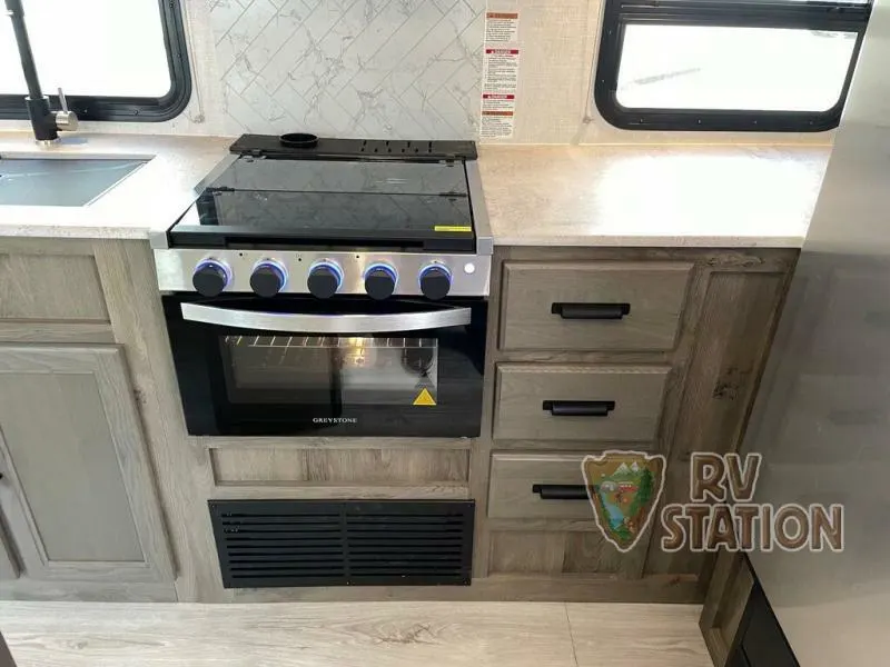 Kitchen with a gas burner, sink and cabinets.