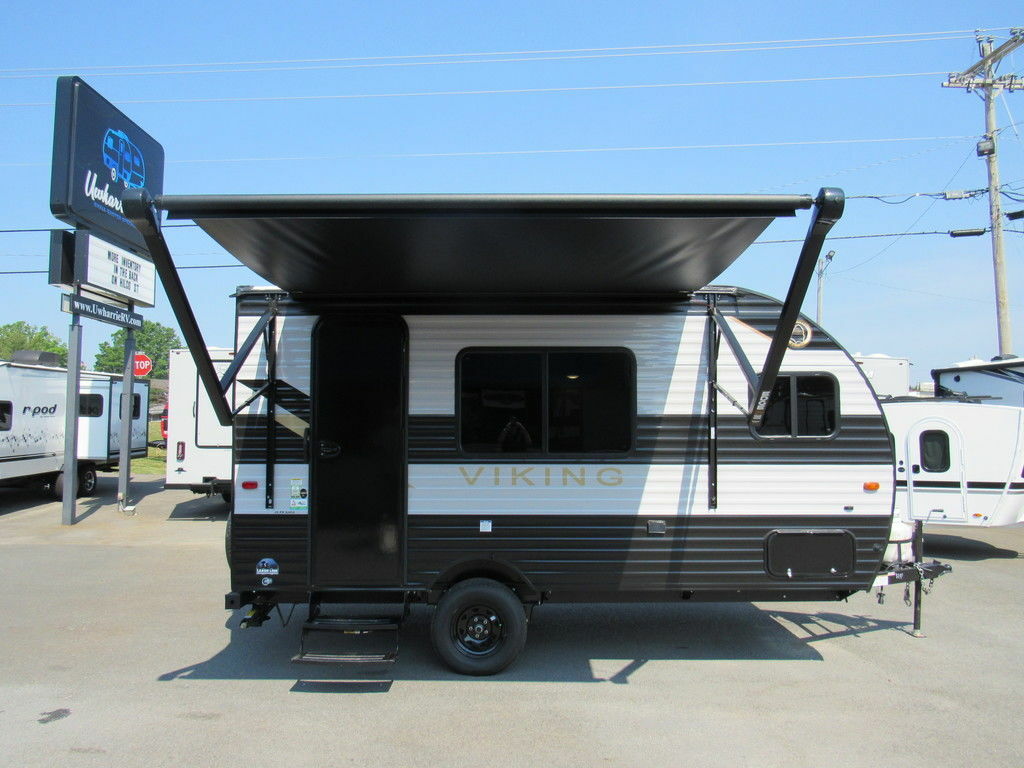 Side view of the RV with an awning.