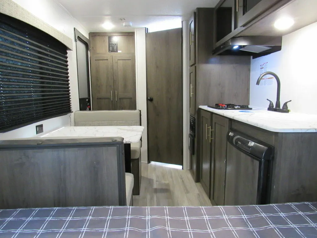 Interior view of the RV with a dinette and a kitchen.