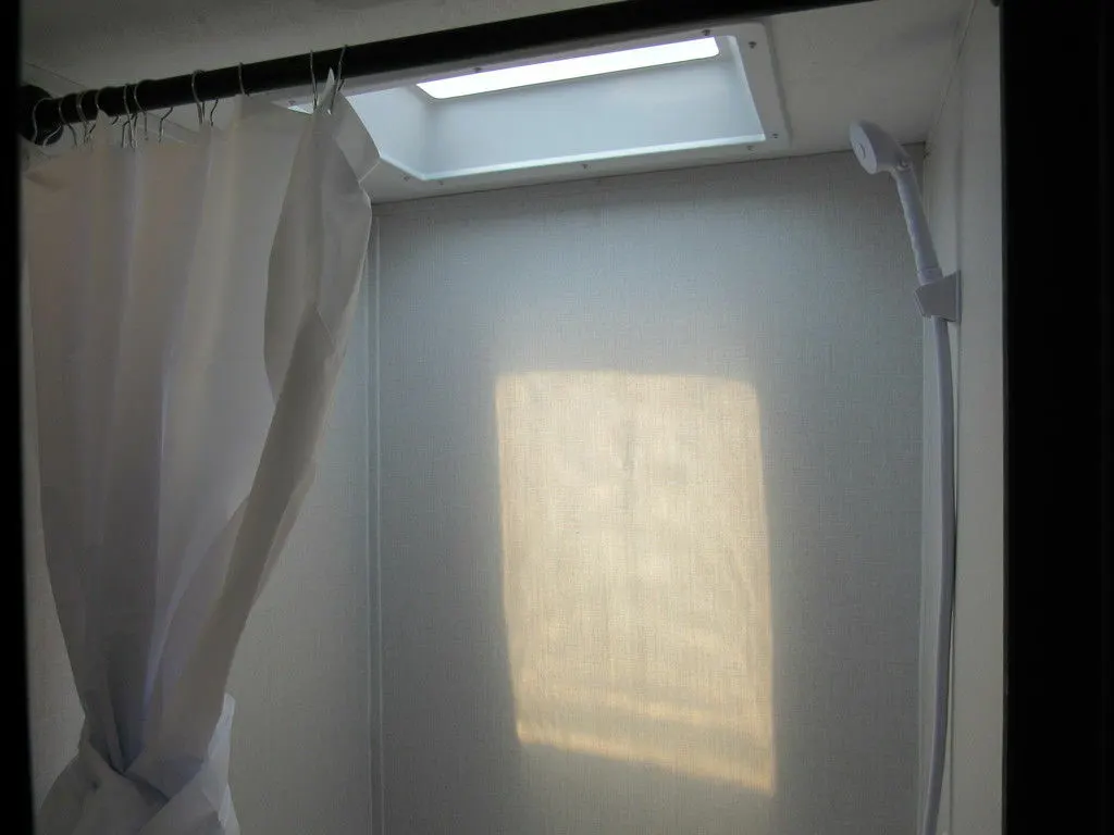 Bathroom with a shower and skylight.