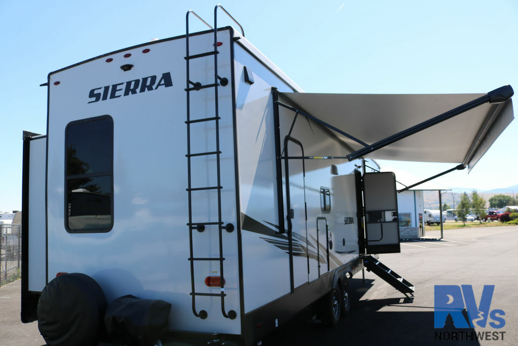 Rear view of the RV with an awning.