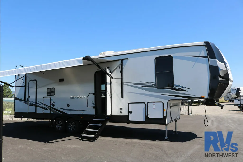 Side view of the RV with an awning.