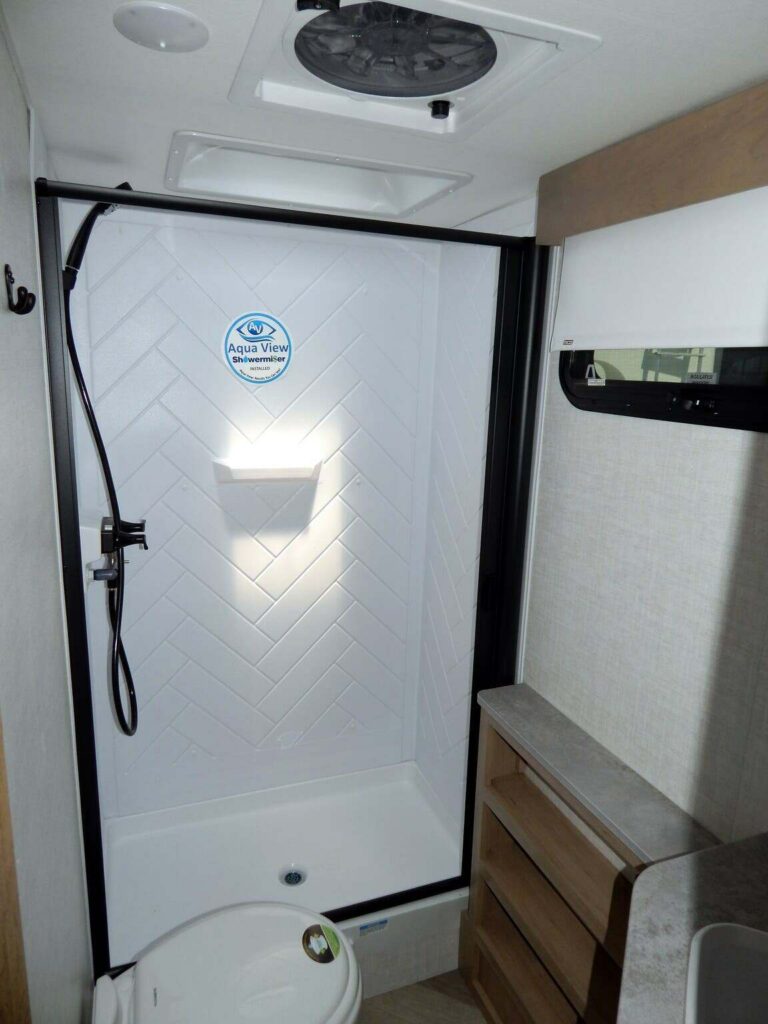 Bathroom with a sink, toilet and a walk-in shower.