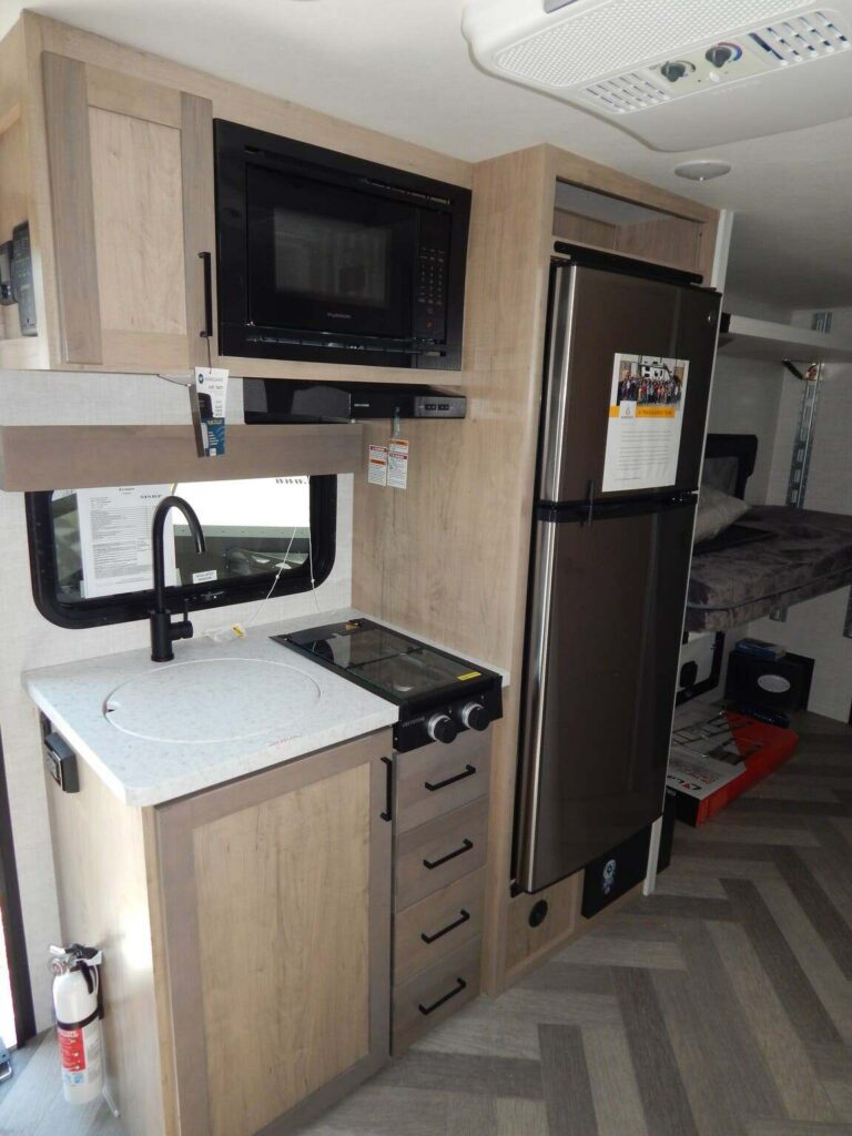 Kitchen with a gas burner, fridge, oven, sink and cabinets.