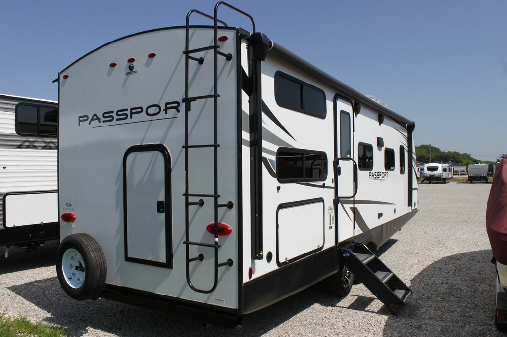 Side view of the RV with an entry door.