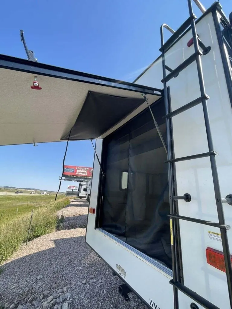 Rear view of the RV with a ladder.