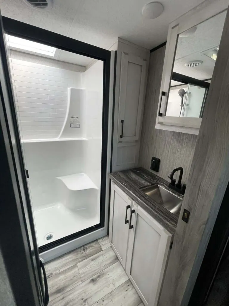 Bathroom with a sink and a walk-in shower.