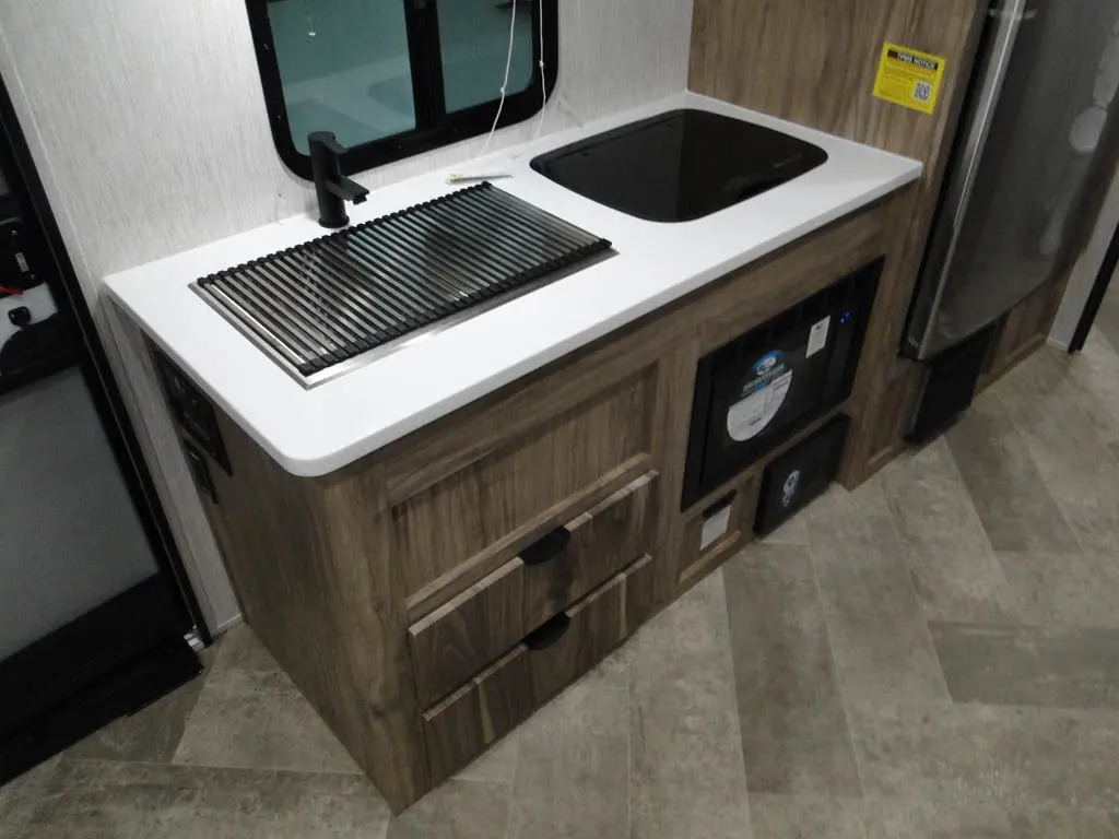 Kitchen with a gas burner, fridge, oven, sink and cabinets.