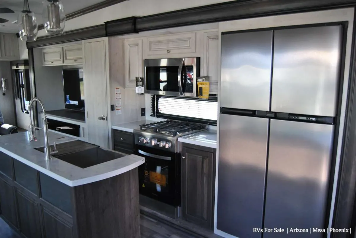 Kitchen with a gas burner, fridge, oven, sink and cabinets.