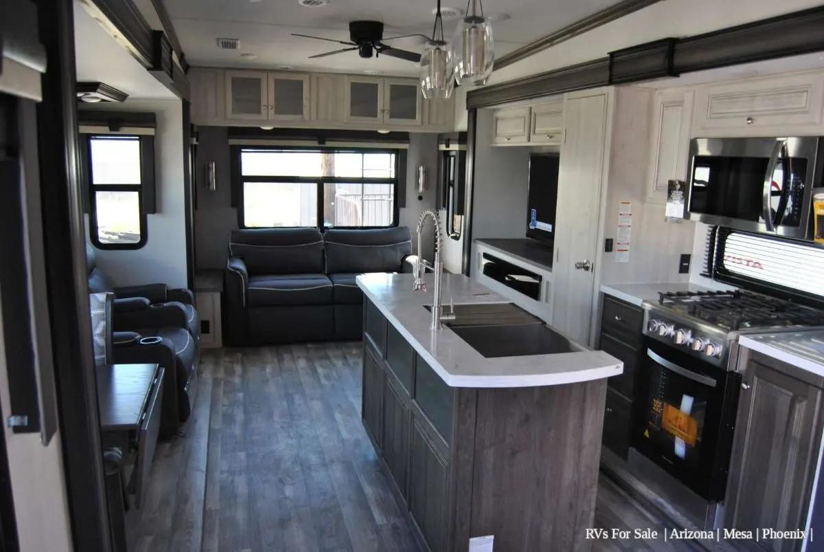 Interior view of the RV with a dinette, living space and a kitchen.