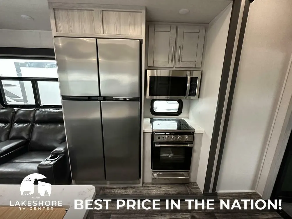 Kitchen with a gas range, fridge, oven, and cabinets.