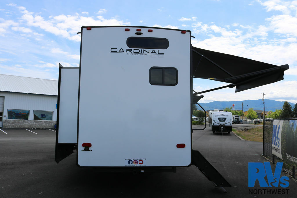 Rear view of the RV with awnings.