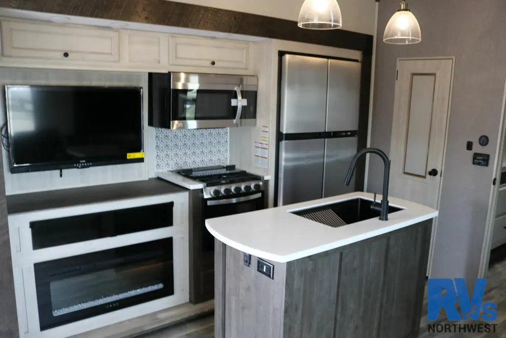 Kitchen with a gas burner, fridge, oven, sink and cabinets.