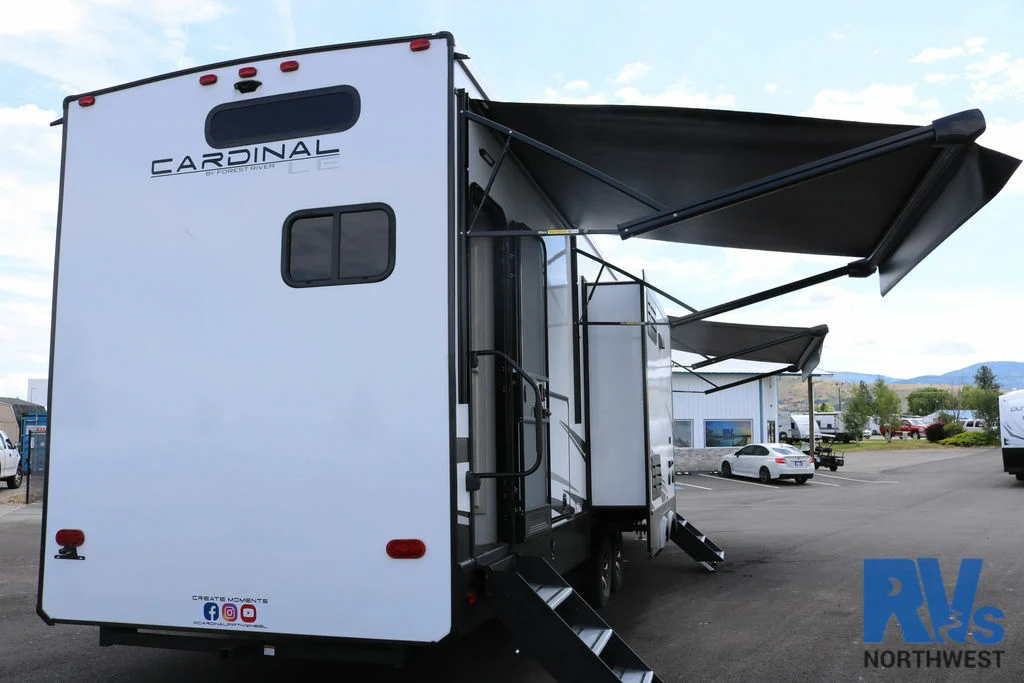 Rear view of the RV with awnings.