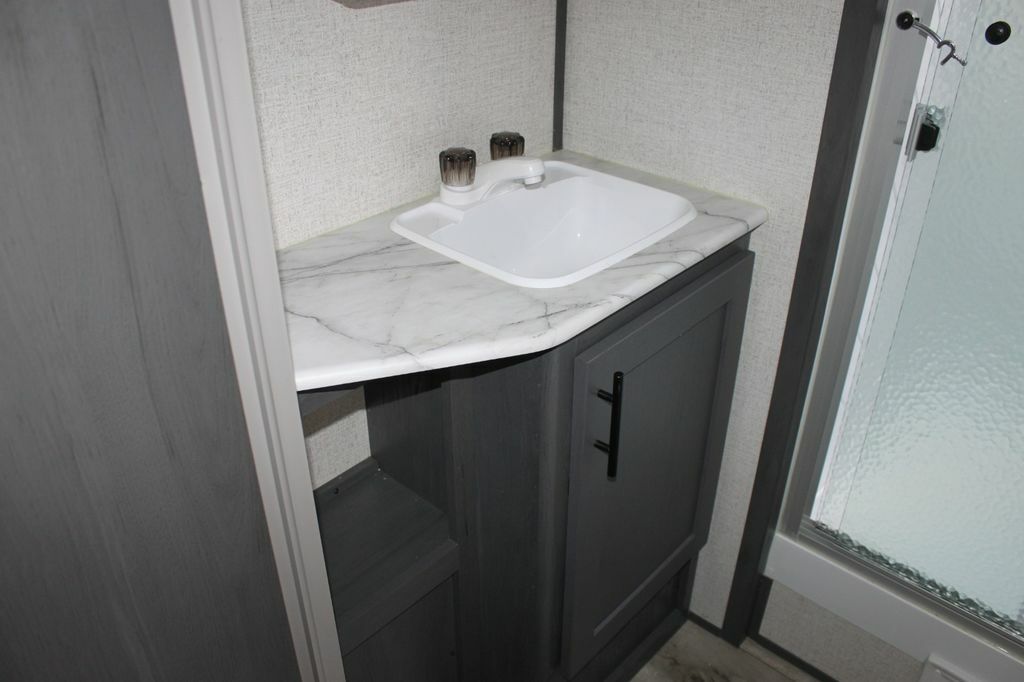 Bathroom with a sink and a walk-in shower.