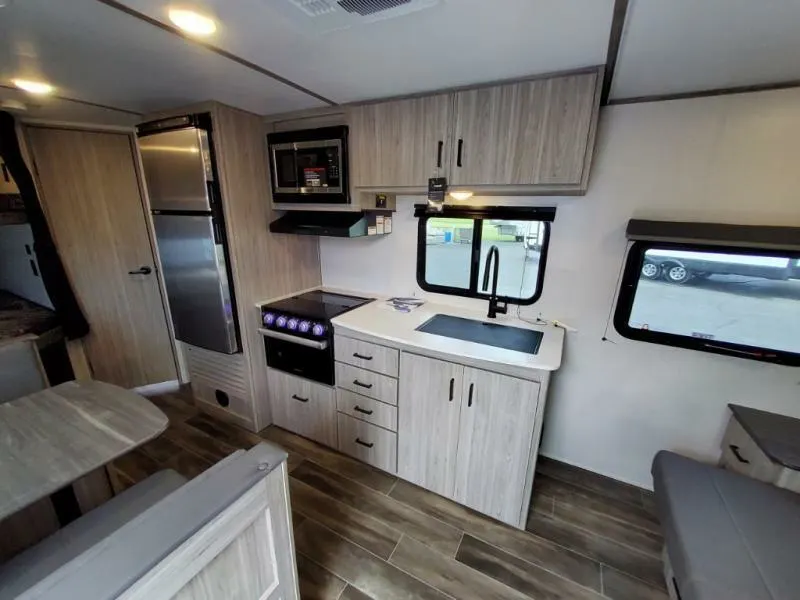 Kitchen with a gas burner, fridge, oven, sink and cabinets.