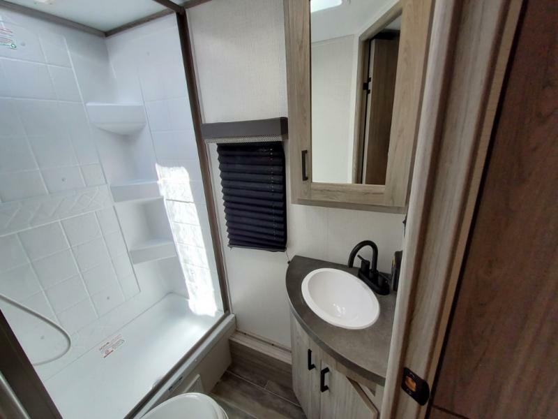 Bathroom with a sink, toilet and a shower.