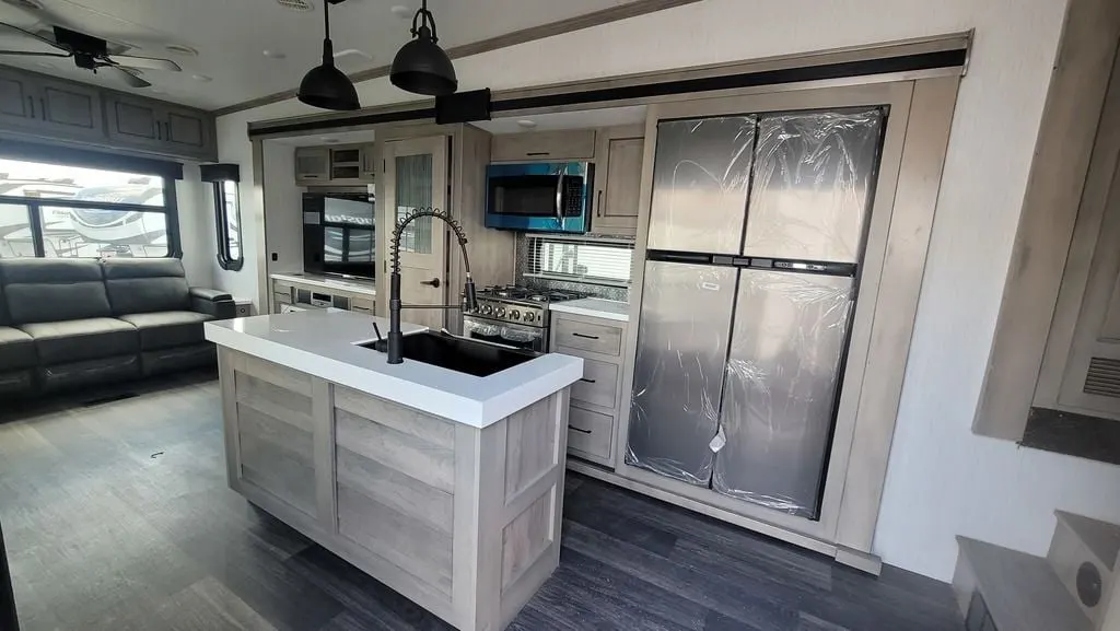 Kitchen with a gas range, fridge, oven, sink and cabinets.