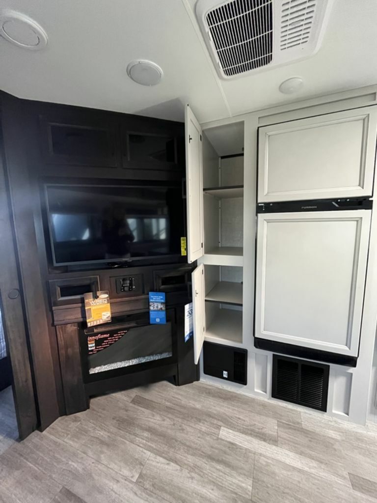 Entertainment center with a TV and a fireplace.