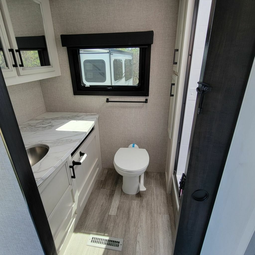 Bathroom with a sink, toilet and a walk-in shower.