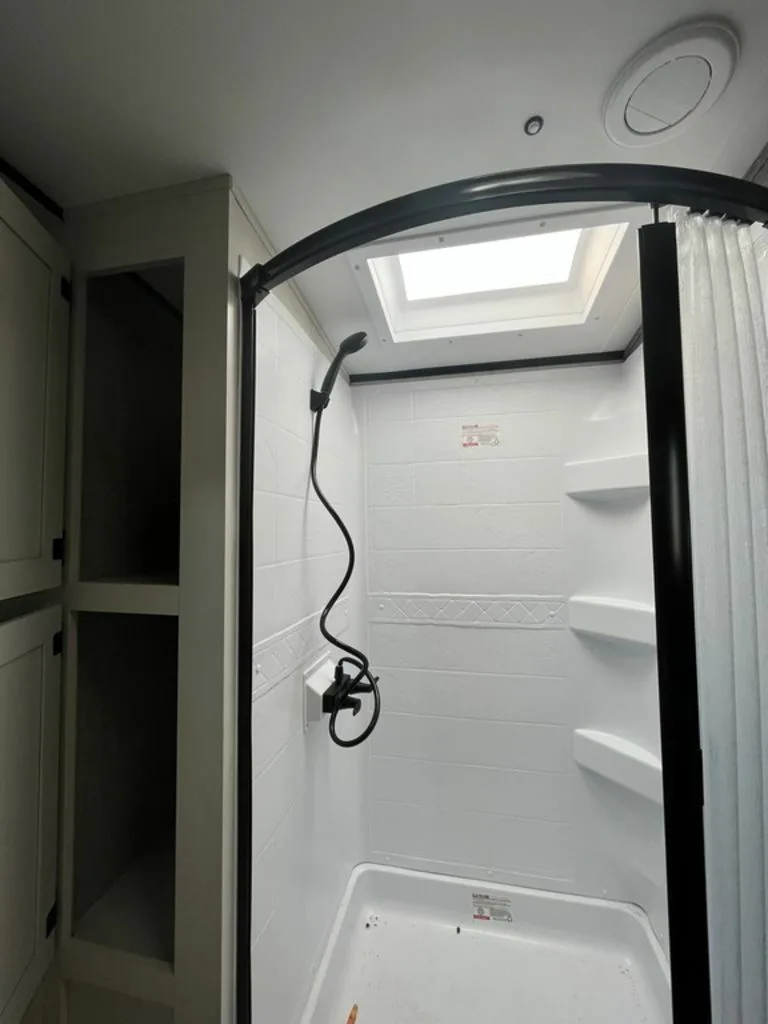 Walk-in shower with skylight.