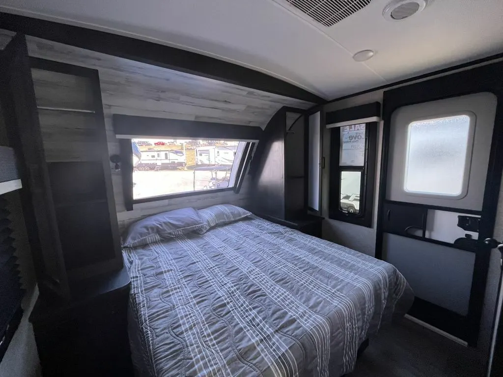 Bedroom with a queen size bed and shirt closets.