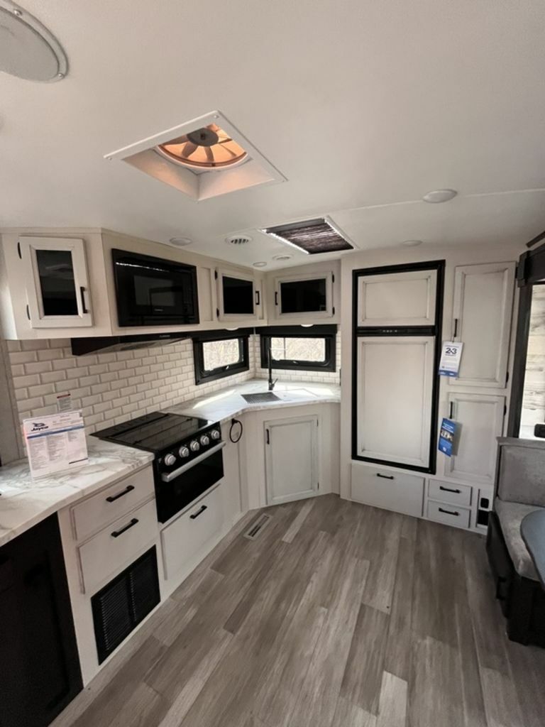 Kitchen with a gas burner, oven, sink and cabinets.