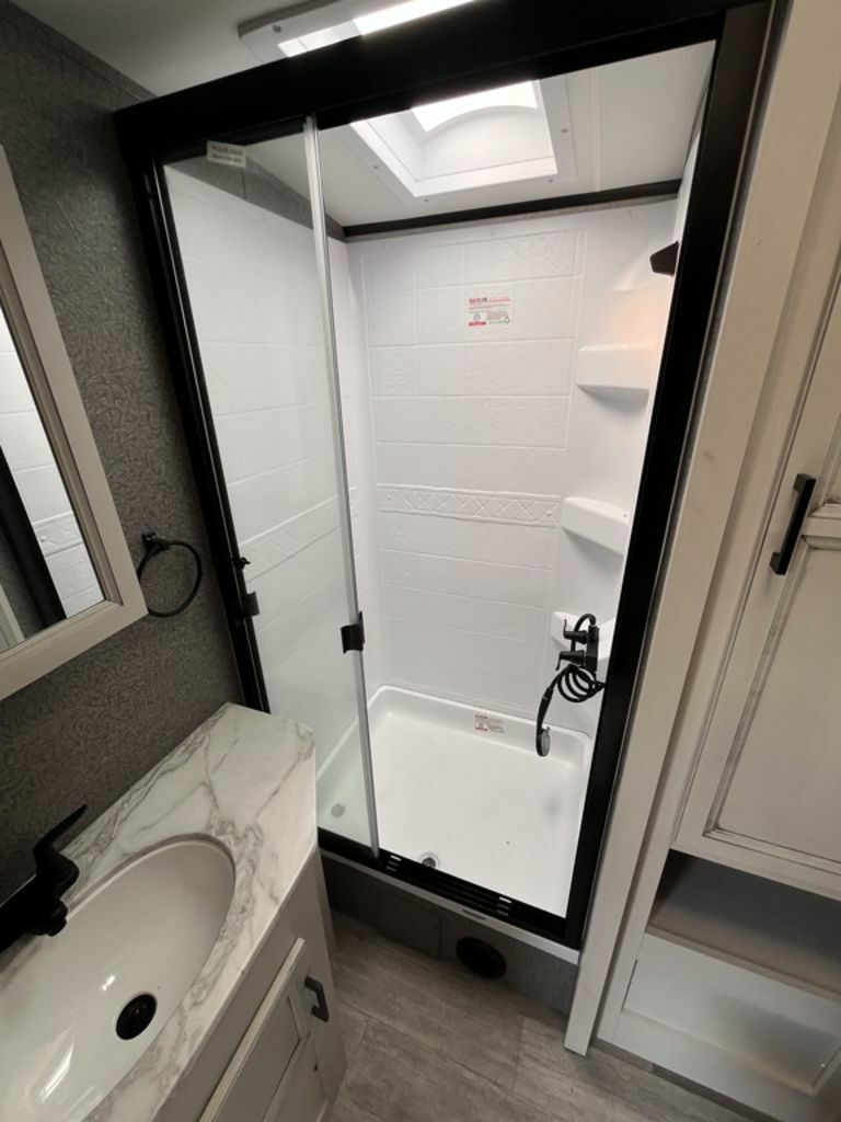 Bathroom with a sink and a walk-in shower.