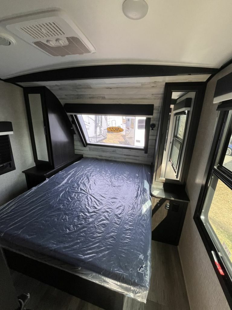 Bedroom with a queen size bed and shirt closets.