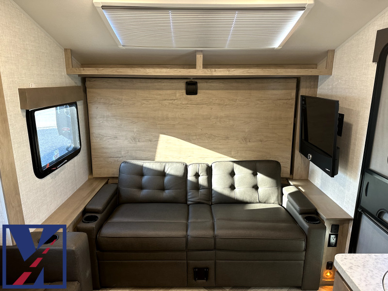 Living space with leather seats and a TV.