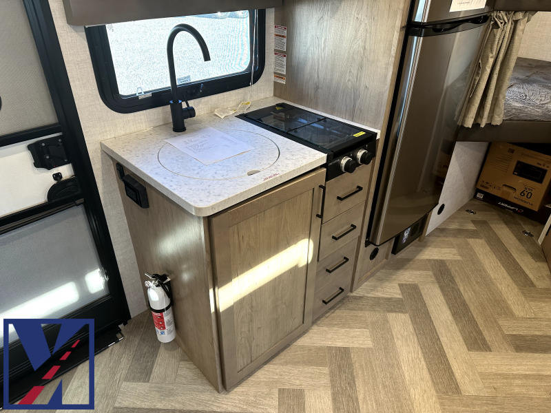 Kitchen with a gas range, fridge, sink and cabinets.