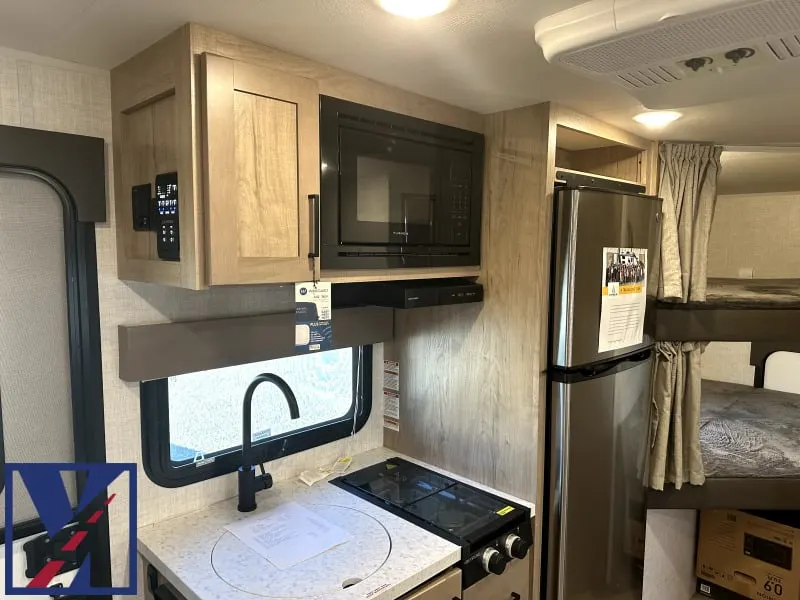 Kitchen with a gas range, fridge, oven, sink and cabinets.