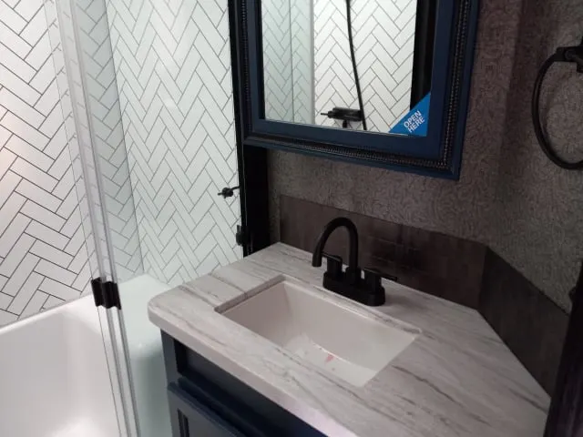 Bathroom with a sink and a walk-in shower.